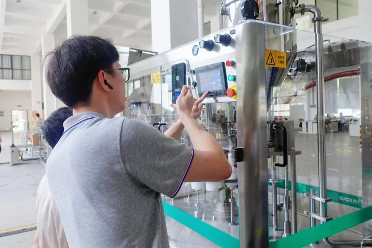 Technician working at the control panel of a packaging machine